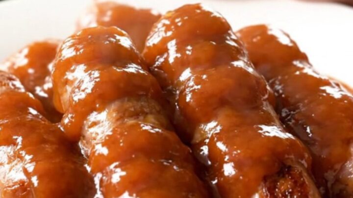 A close-up of honey chipotle sausage and baby gold potatoes in a slow cooker.