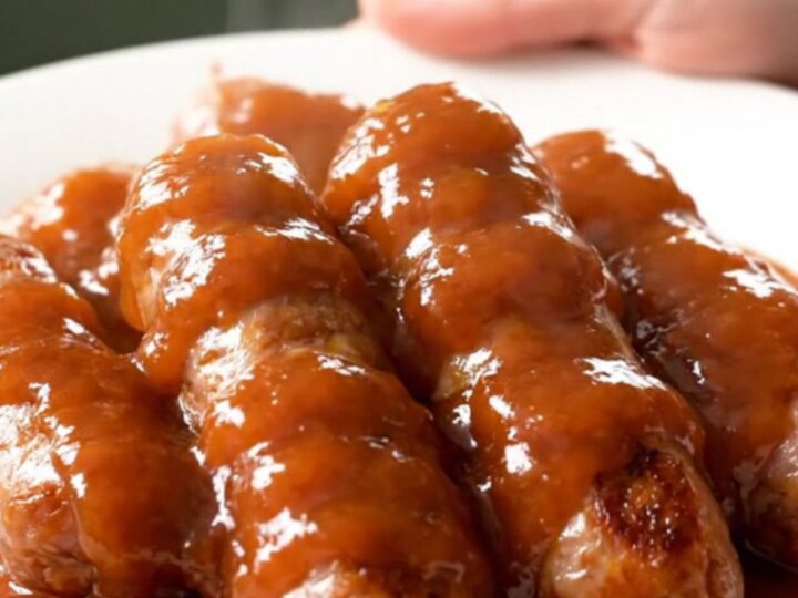A close-up of honey chipotle sausage and baby gold potatoes in a slow cooker.