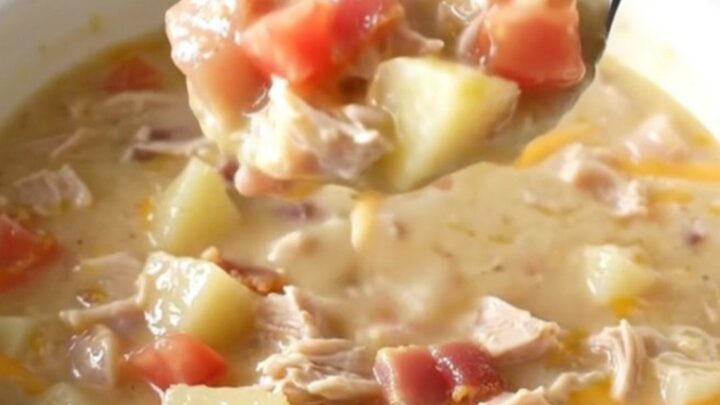 A creamy turkey club chowder in a rustic bowl, topped with crispy bacon and melted cheddar cheese.