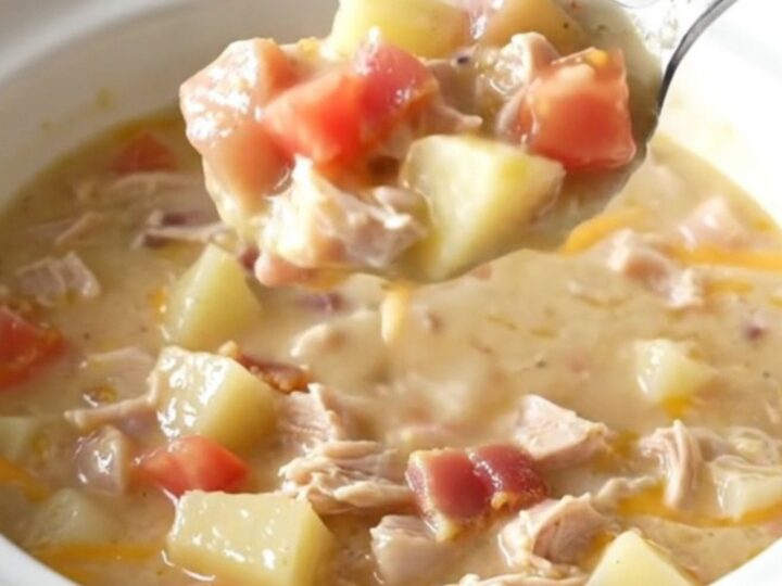 A creamy turkey club chowder in a rustic bowl, topped with crispy bacon and melted cheddar cheese.
