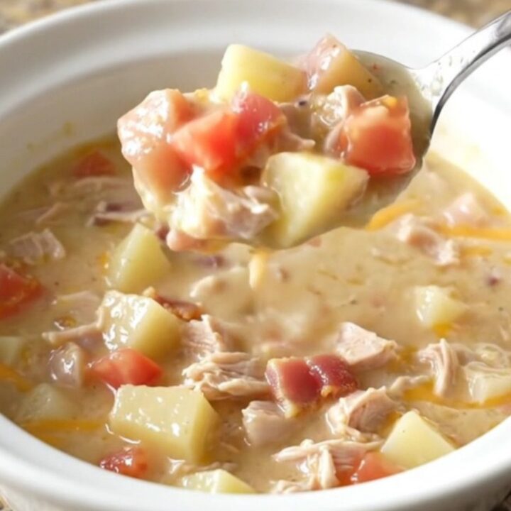 A creamy turkey club chowder in a rustic bowl, topped with crispy bacon and melted cheddar cheese.