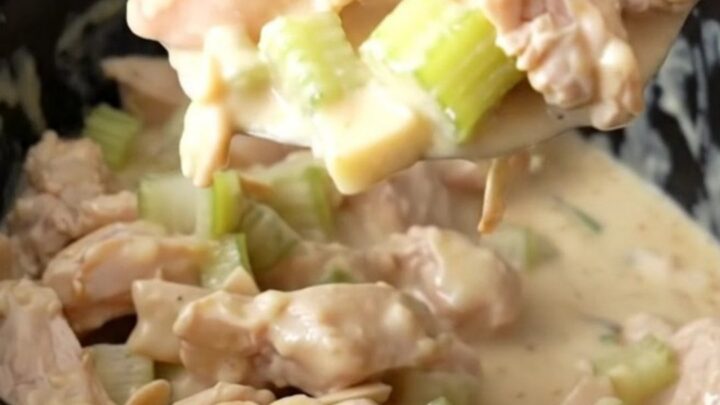 Creamy almond chicken with visible chicken pieces and slivered almonds in a white bowl.