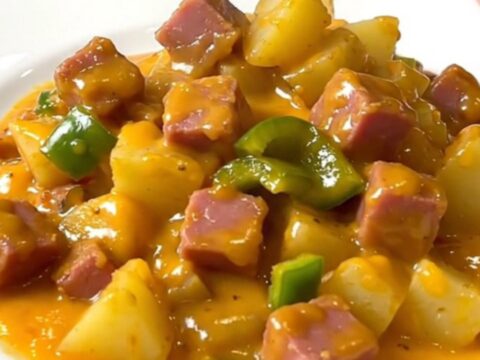 A close-up view of the finished Denver ham and cheddar potatoes in a slow cooker, showing creamy sauce.