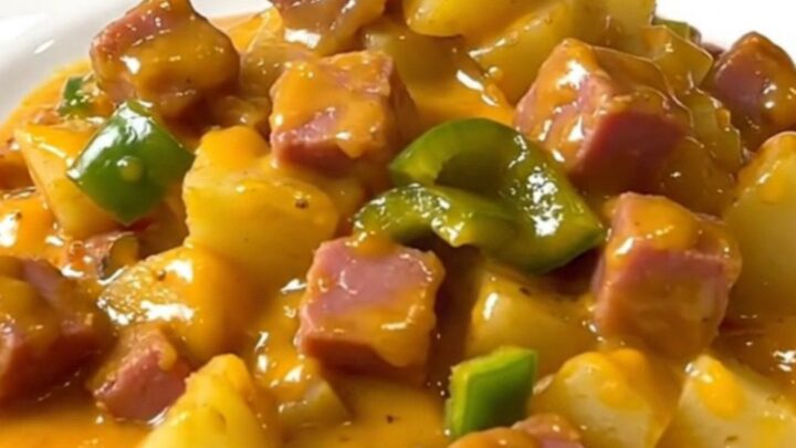 A close-up view of the finished Denver ham and cheddar potatoes in a slow cooker, showing creamy sauce.