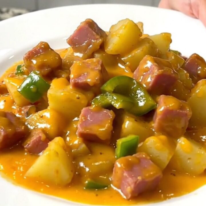 A close-up view of the finished Denver ham and cheddar potatoes in a slow cooker, showing creamy sauce.