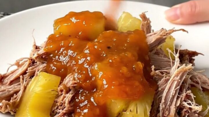 A close-up of pineapple habanero pulled pork sliders on a platter with steam rising.