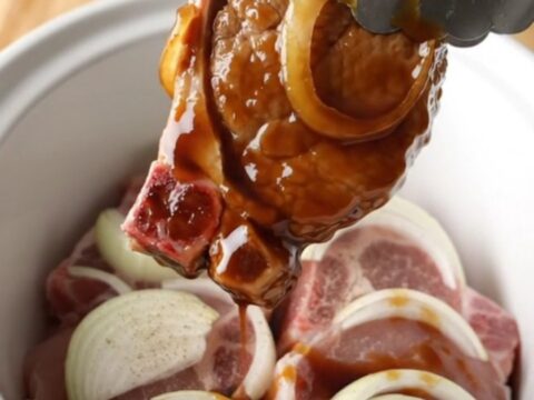 Tender slow-cooked pork chops glazed in a rich, dark sweet soy sauce with soft onion slices.