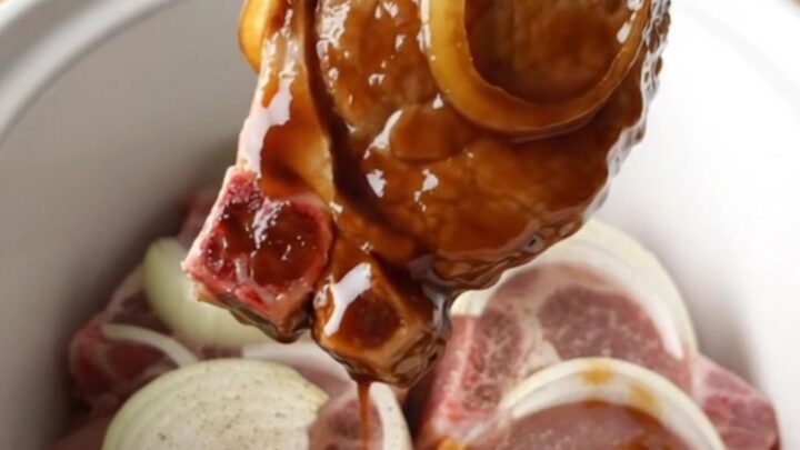 Tender slow-cooked pork chops glazed in a rich, dark sweet soy sauce with soft onion slices.