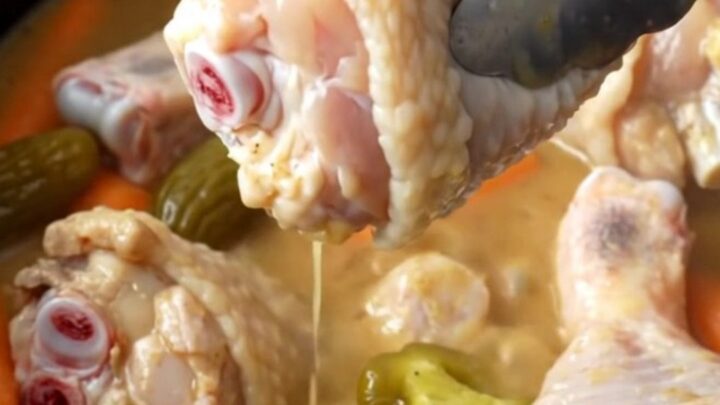 Slow cooker Mississippi chicken drumsticks with bright orange baby carrots and green pepperoncini in a savory buttery gravy.