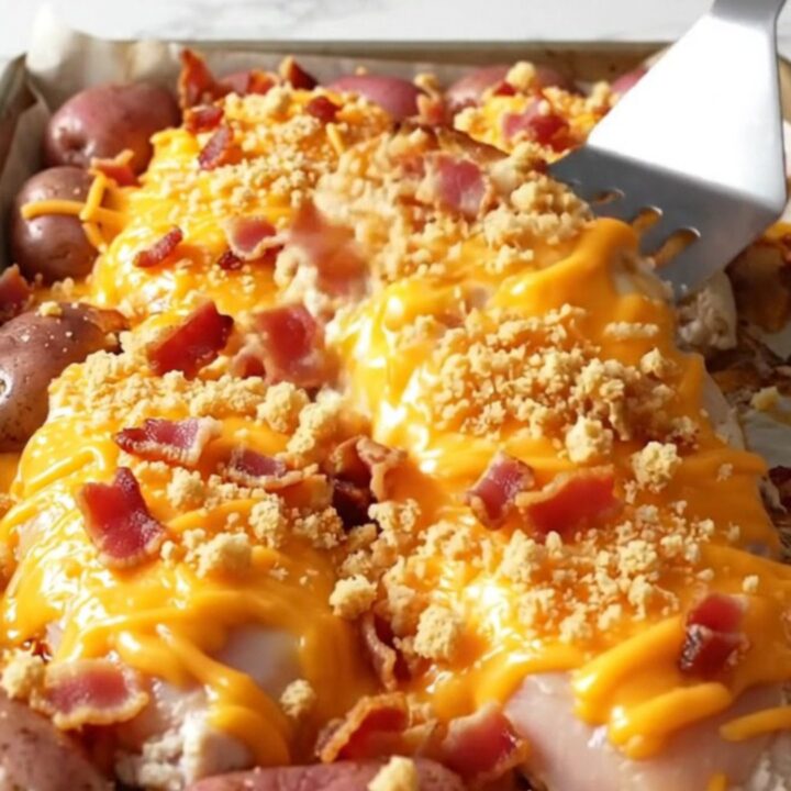 A golden, cheesy sheet pan chicken and potato dinner fresh from the oven.