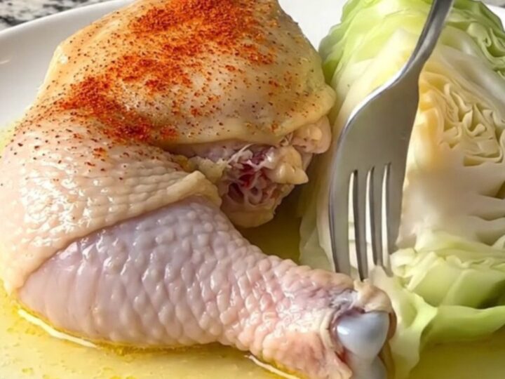 Slow cooker chicken thighs with smoky paprika and cabbage in a black stoneware insert.
