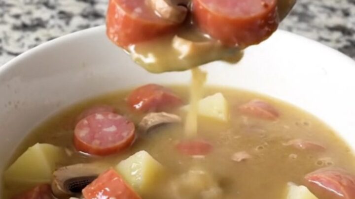 A bowl of creamy kielbasa stroganoff soup featuring sliced sausage, mushrooms, and gold potatoes in a rich, creamy broth.