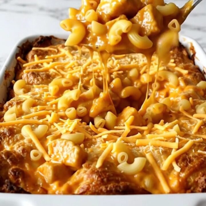 A golden, bubbling Nashville Hot Chicken Mac and Cheese bake in a white rectangular ceramic dish.
