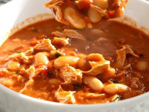 A close-up view of the slow cooker filled with hearty Italian white bean turkey chili.