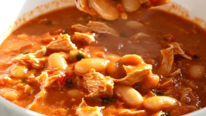 A close-up view of the slow cooker filled with hearty Italian white bean turkey chili.