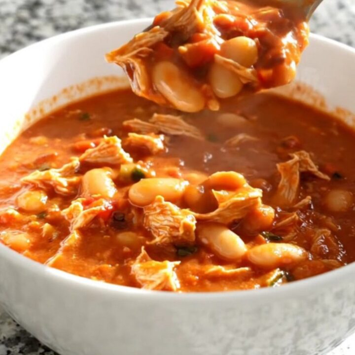 A close-up view of the slow cooker filled with hearty Italian white bean turkey chili.
