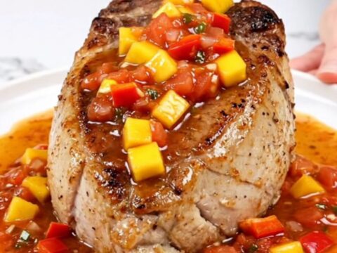 Slow cooker pork tenderloin topped with a vibrant mixture of diced mango, red pepper, and salsa.