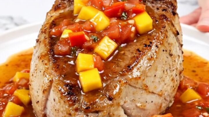 Slow cooker pork tenderloin topped with a vibrant mixture of diced mango, red pepper, and salsa.
