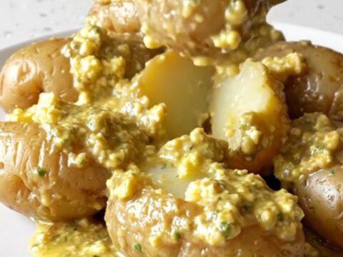 A close-up view of creamy garlic herb potatoes in a slow cooker, looking rich and appetizing.