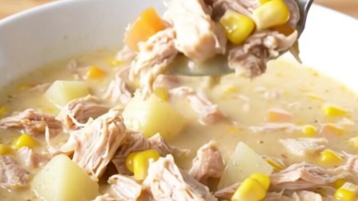 A bowl of creamy Crockpot Cheesy Turkey Corn Chowder with visible turkey crumbles and corn kernels.