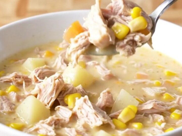 A bowl of creamy Crockpot Cheesy Turkey Corn Chowder with visible turkey crumbles and corn kernels.