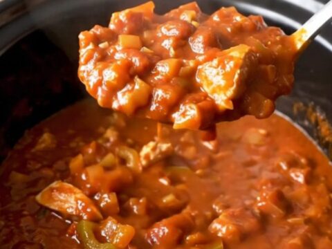 A close-up of the finished turkey chili served in a bowl, showing the texture of the meat, beans, and peppers.