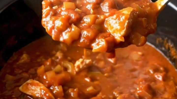 A close-up of the finished turkey chili served in a bowl, showing the texture of the meat, beans, and peppers.