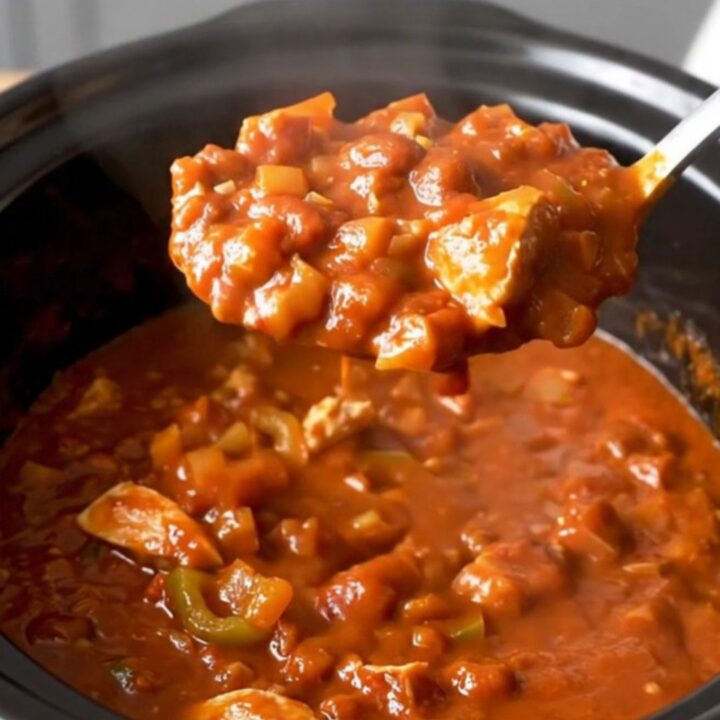 A close-up of the finished turkey chili served in a bowl, showing the texture of the meat, beans, and peppers.