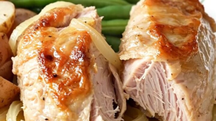 Slow cooker turkey tenderloin with green beans and red potatoes in a savory onion sauce.