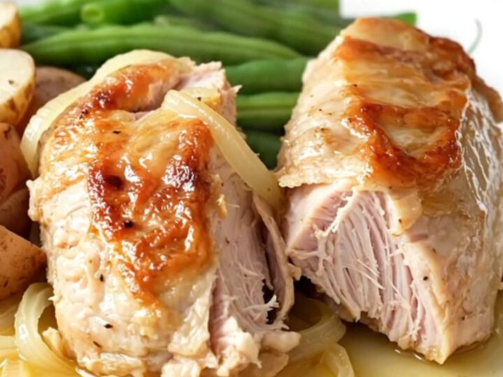 Slow cooker turkey tenderloin with green beans and red potatoes in a savory onion sauce.