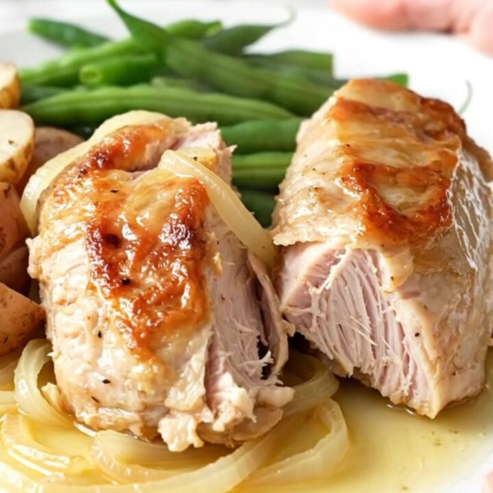 Slow cooker turkey tenderloin with green beans and red potatoes in a savory onion sauce.
