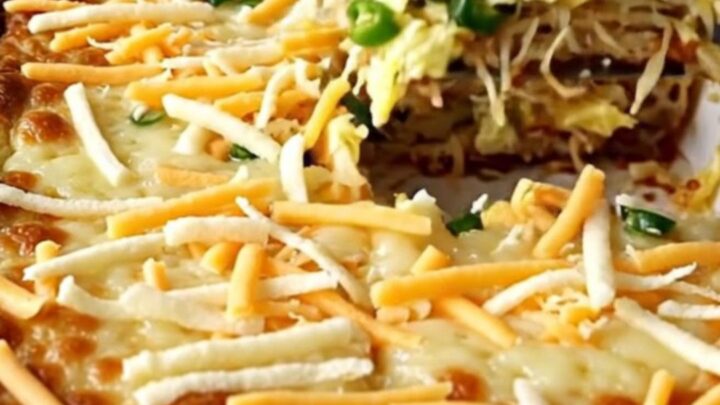 A top-down view of a rectangular ceramic baking dish filled with a golden, baked hash brown and egg casserole.