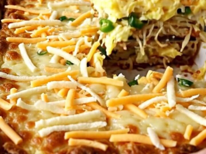 A top-down view of a rectangular ceramic baking dish filled with a golden, baked hash brown and egg casserole.