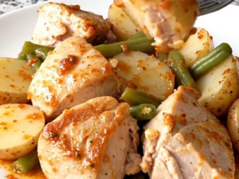 A hearty bowl of Cajun chicken with baby potatoes and green beans in a savory butter sauce.