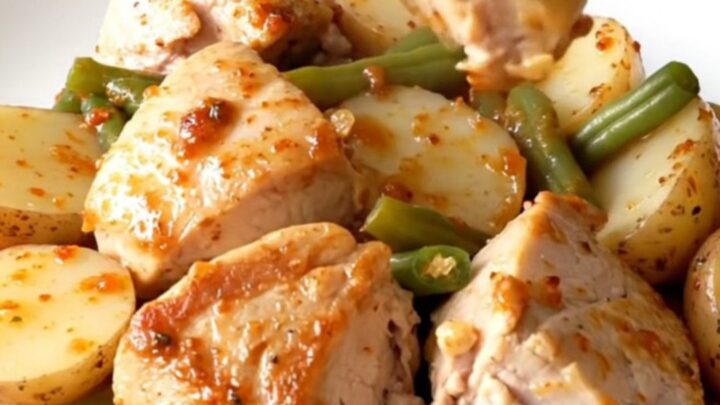 A hearty bowl of Cajun chicken with baby potatoes and green beans in a savory butter sauce.