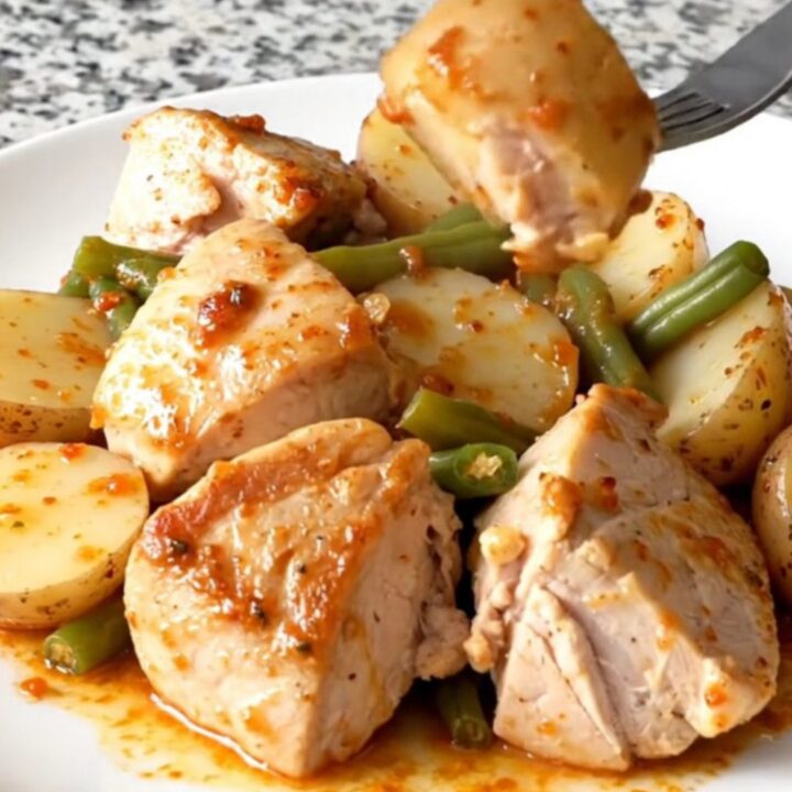 A hearty bowl of Cajun chicken with baby potatoes and green beans in a savory butter sauce.
