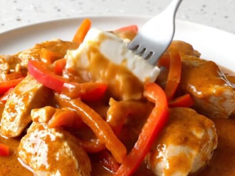 Creamy gochujang chicken breasts with red bell peppers in a rich orange-red sauce.