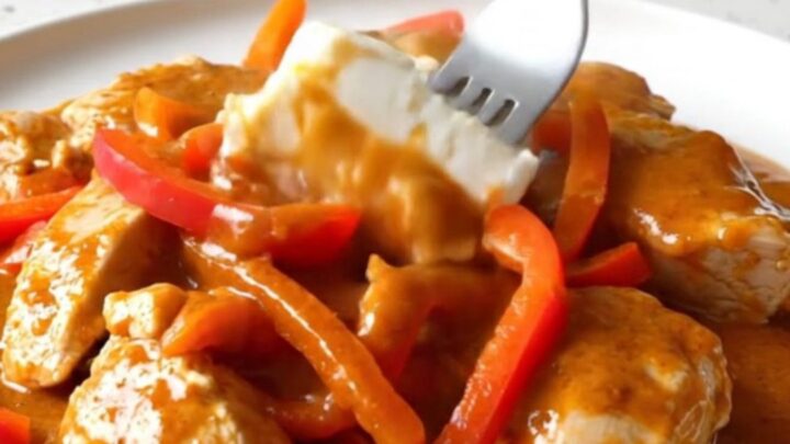 Creamy gochujang chicken breasts with red bell peppers in a rich orange-red sauce.