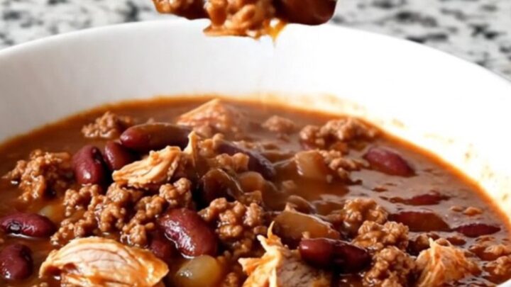 A close-up shot of a bowl of hearty beer chili with ground turkey and kidney beans.