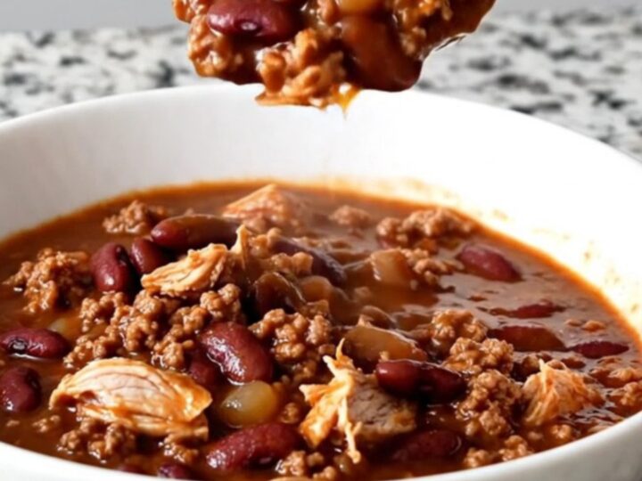 A close-up shot of a bowl of hearty beer chili with ground turkey and kidney beans.