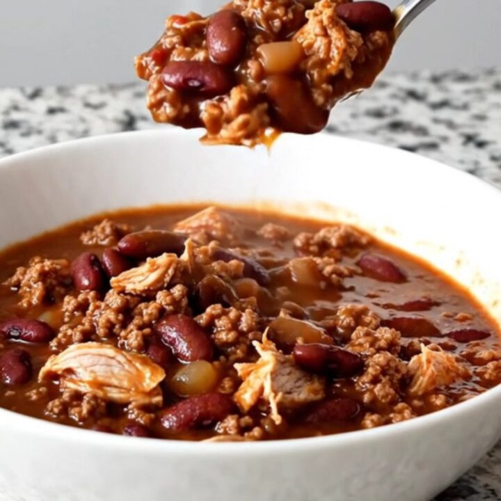 A close-up shot of a bowl of hearty beer chili with ground turkey and kidney beans.