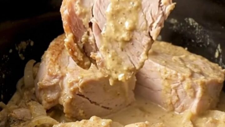 A close-up of tender, creamy Crockpot Swedish Pork Chops served with mushroom gravy.