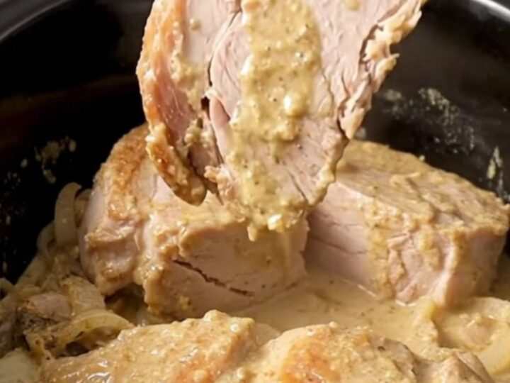 A close-up of tender, creamy Crockpot Swedish Pork Chops served with mushroom gravy.