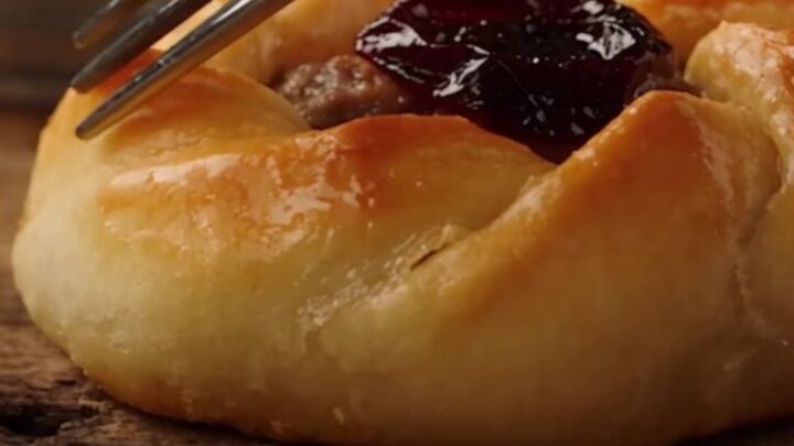 A close-up of a freshly baked Antakya Kaytaz borek showing a golden, blistered, and flaky pastry crust.