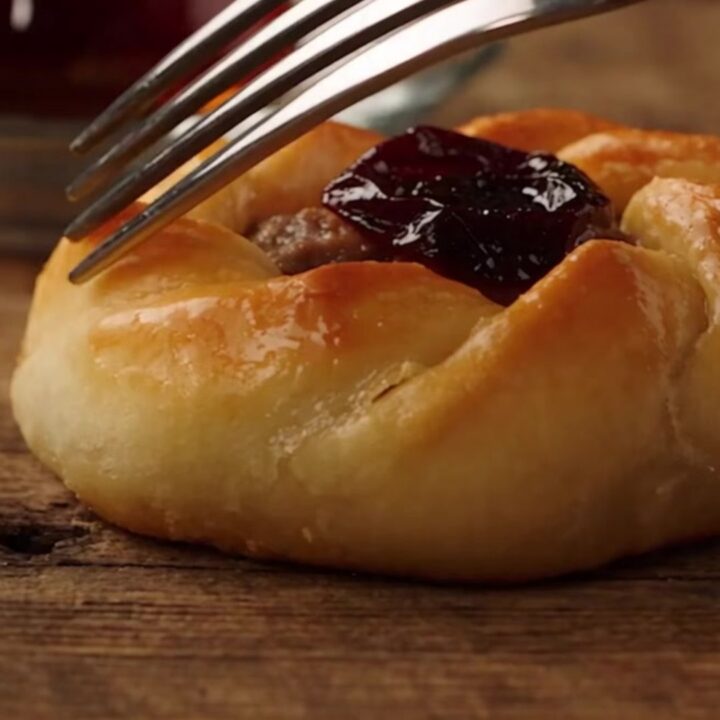 A close-up of a freshly baked Antakya Kaytaz borek showing a golden, blistered, and flaky pastry crust.