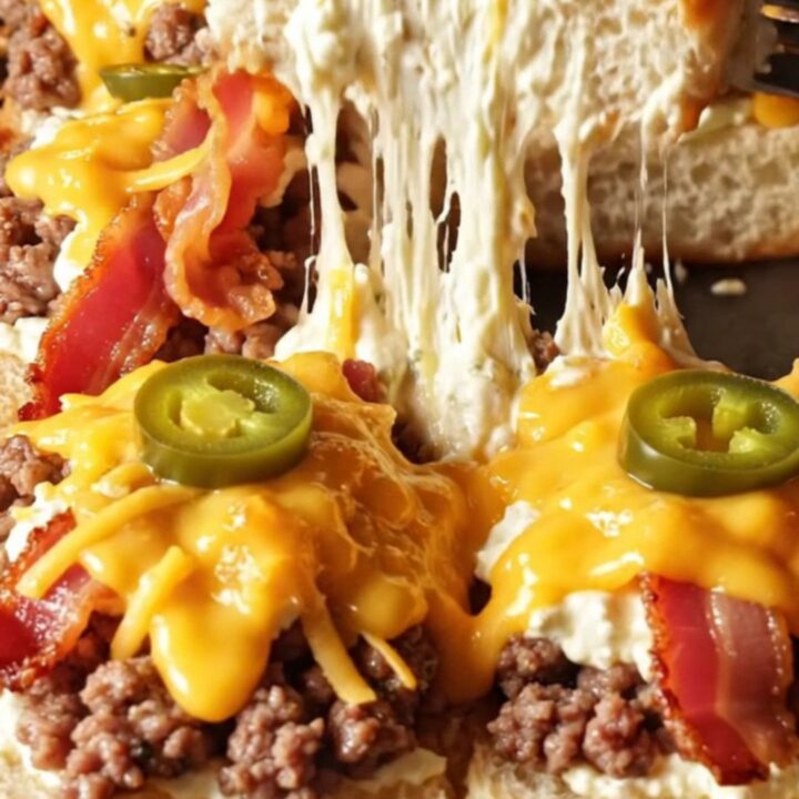 A close-up shot of a jalapeño popper beef slider showing molten cheese and crispy bacon.