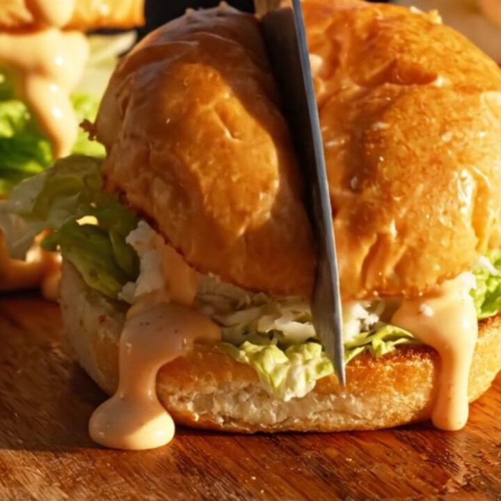 A golden jumbo lump crab cake slider on a toasted brioche bun with remoulade.