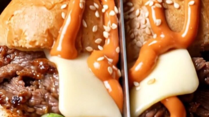 A close-up shot of a Korean bulgogi cheesesteak sub with melted American cheese and gochujang mayo.