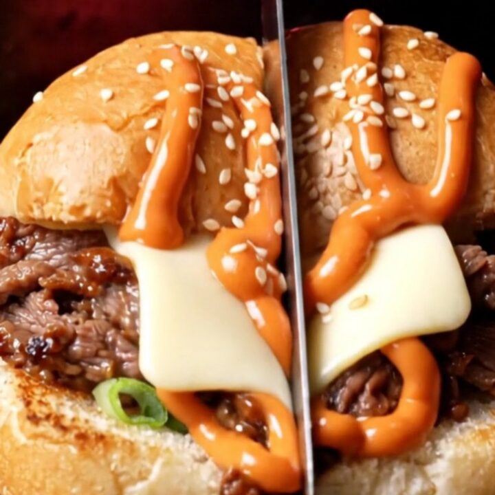 A close-up shot of a Korean bulgogi cheesesteak sub with melted American cheese and gochujang mayo.