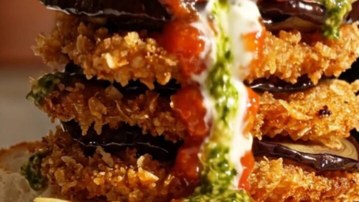 A crispy golden-fried eggplant parmigiana sandwich on toasted ciabatta with creamy burrata and basil pesto.